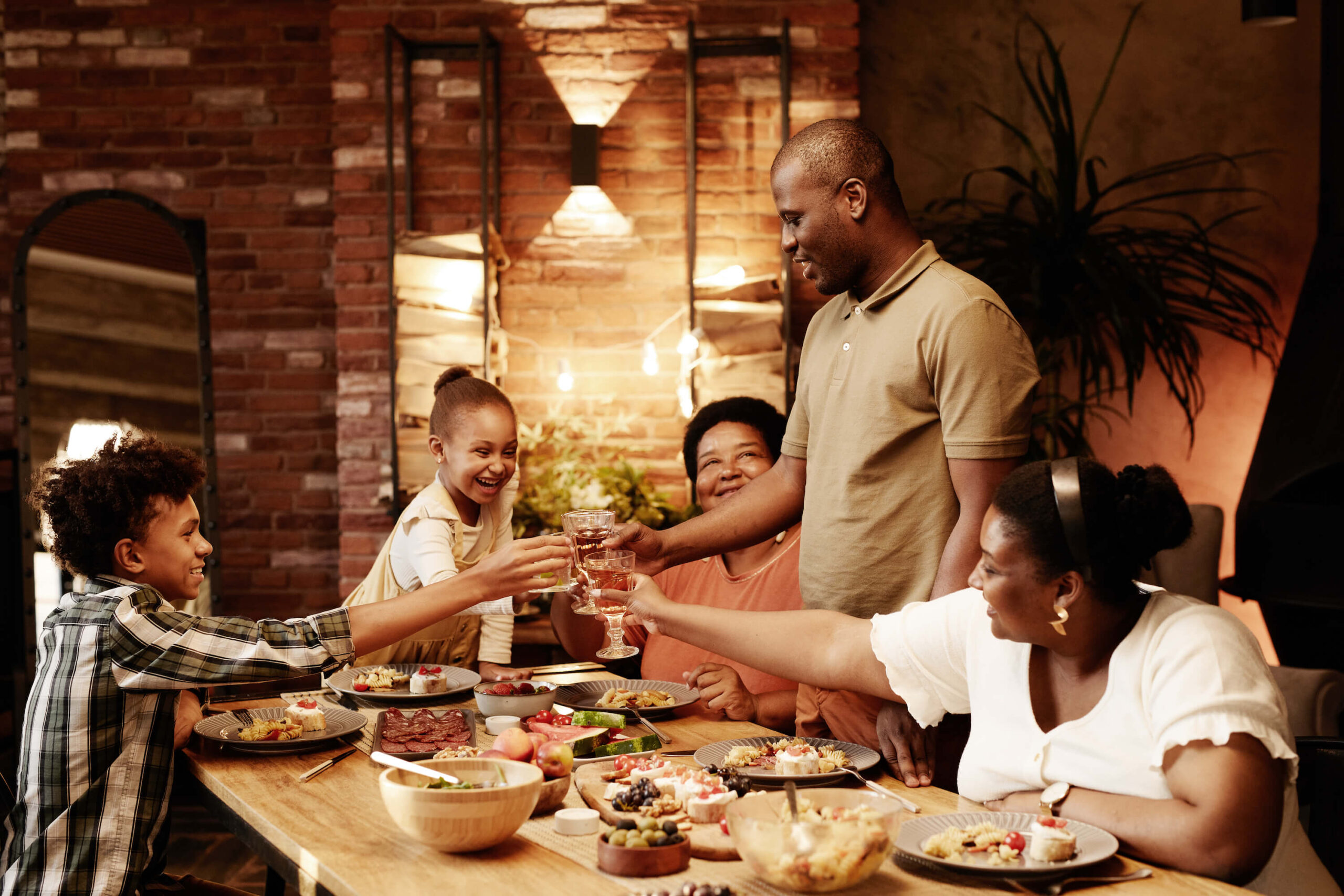 african-american-family-celebrating-at-dinner-2023-11-27-04-49-59-utc